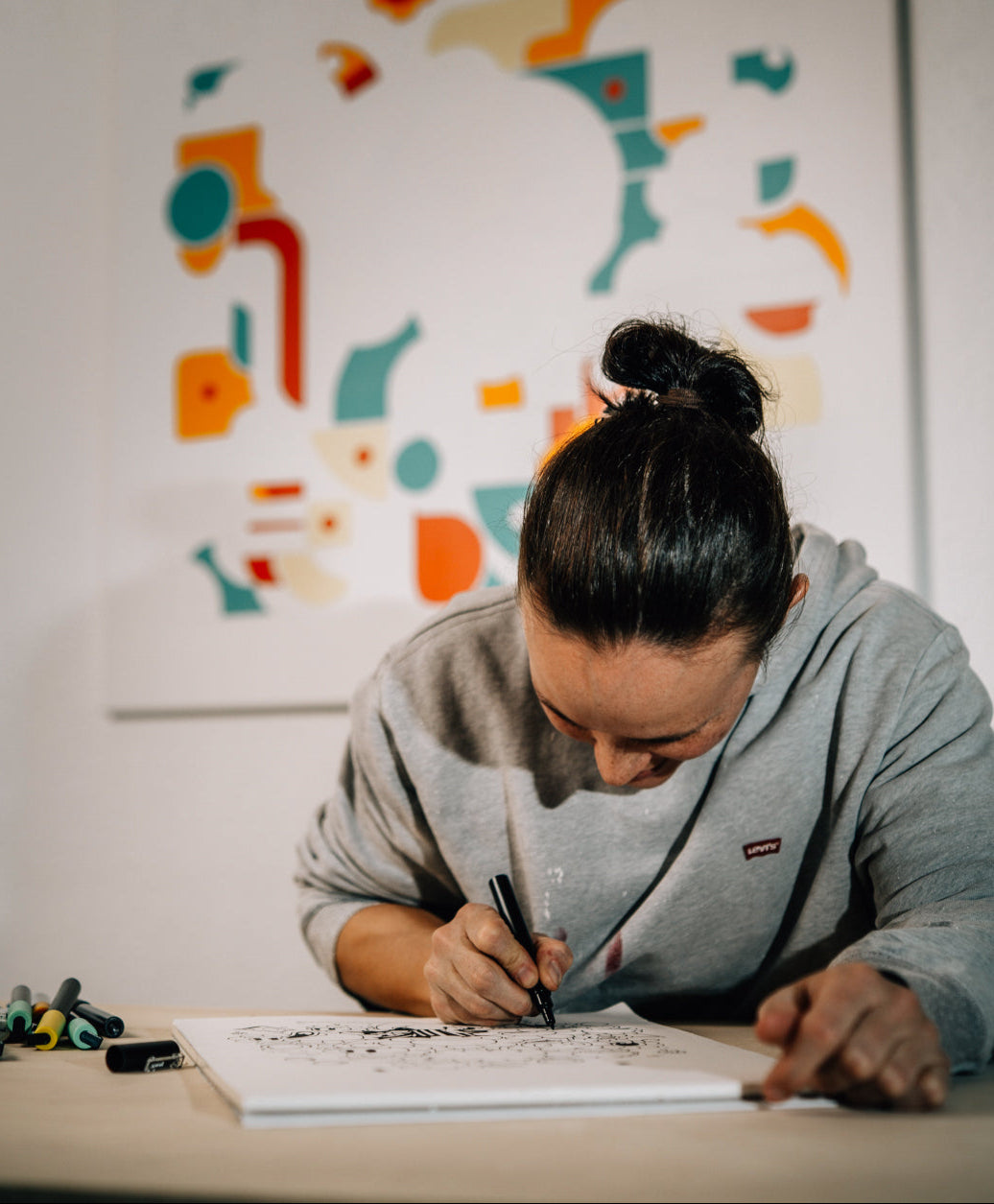 Artist drawing cartoon-inspired Billionaire Bathing Duck character on a paper, focused on a rich univers and funny details