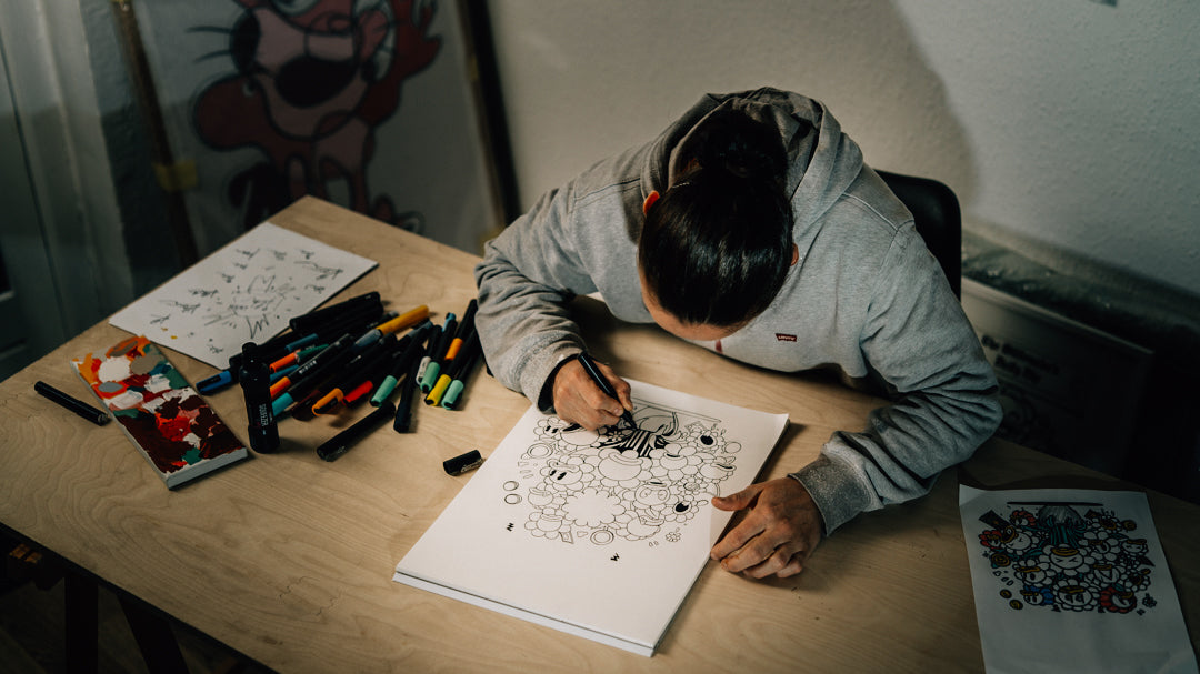 Artist drawing the character's of Billionaire Bathing Duck, focused on playful cartoon-style expressions and funny details